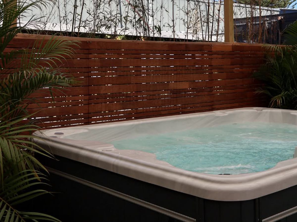 Outdoor mineral spa surrounded by palms